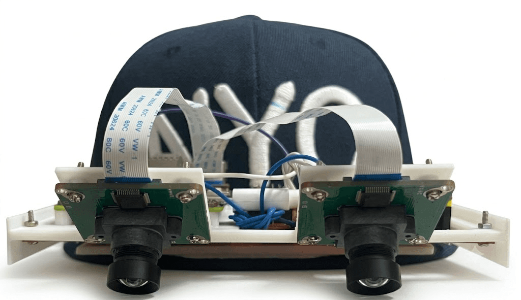 Prototype Akai EgoStack rig with stereo cameras on a head-worn frame